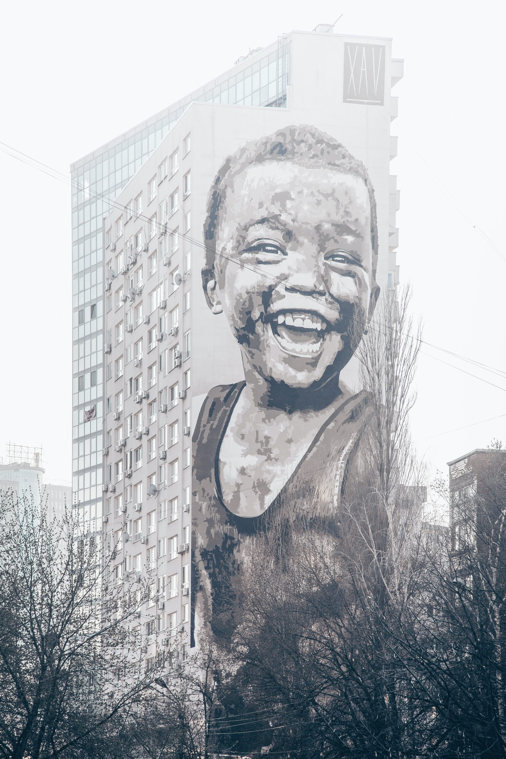 Mural on side of building of young boy smiling by Marja Murd from Unsplash