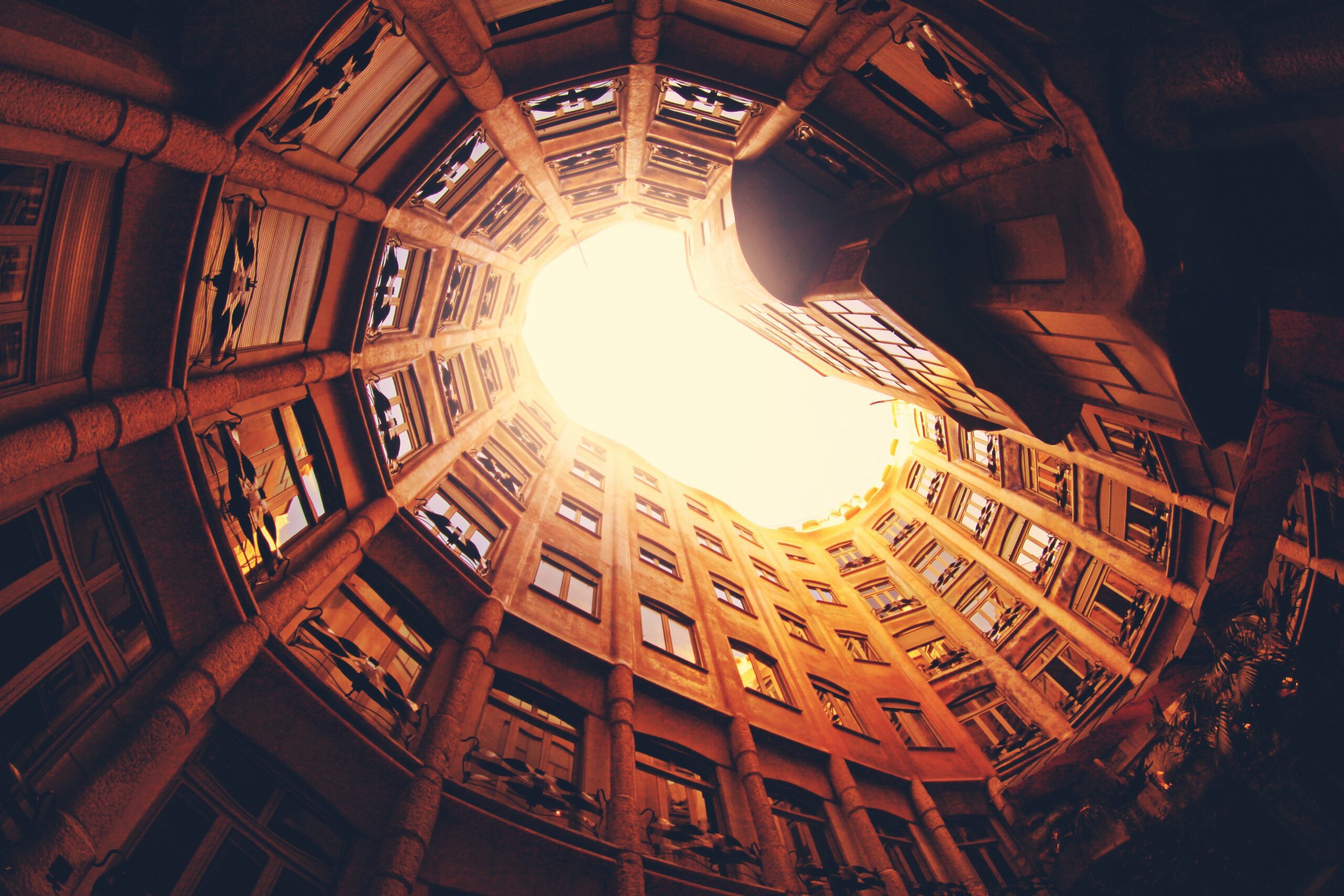 alexandre-perotto-Barcelona City image looking up to sky-sunlight-unsplash