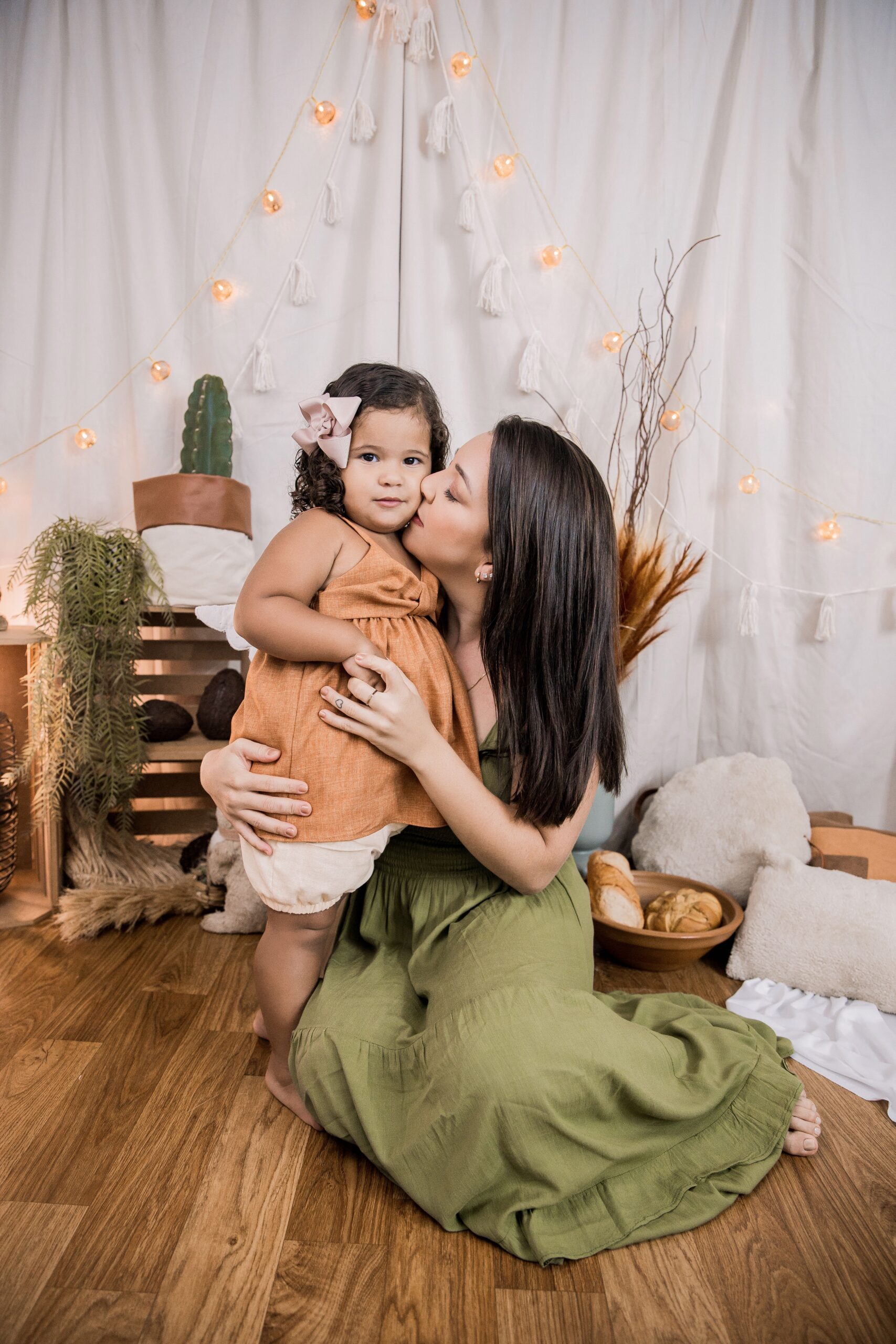 junior-reis-Mother sitting down embracing daugher standing next-unsplash