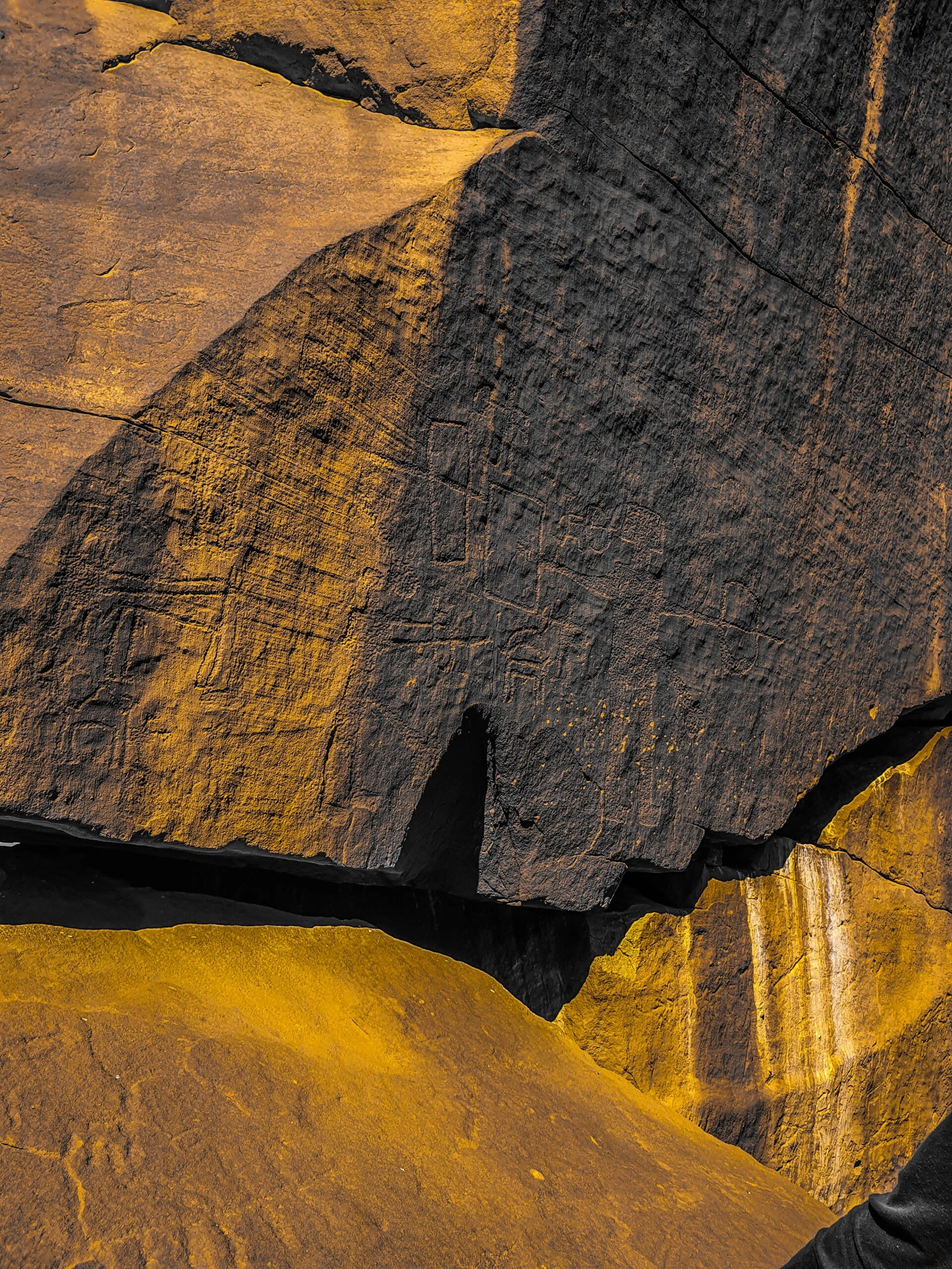 m-k-_side of Rock face with petroglyph carvings-unsplash