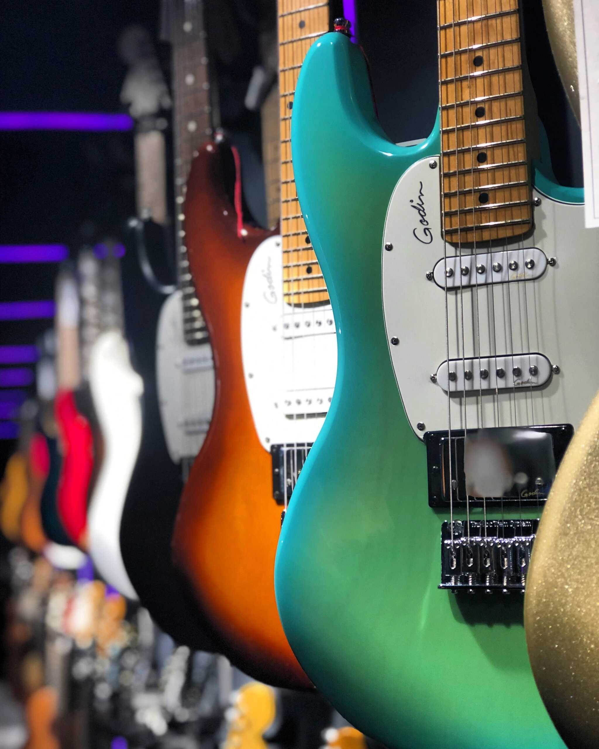 Row of electric guitars in shop by Mohrez Labaf