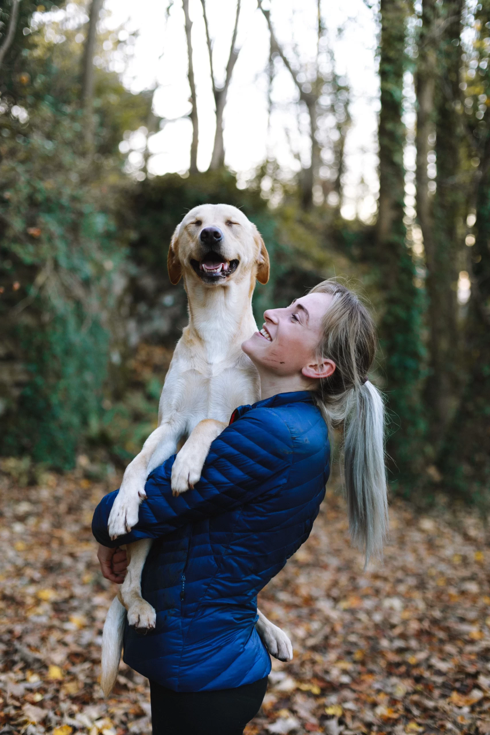 humphrey-muleba-Golden dog held in owners arms with head up and eyes closed in joy-unsplash