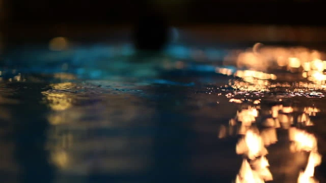 Night Swimming I Stock photo of woman in dark water night swimming