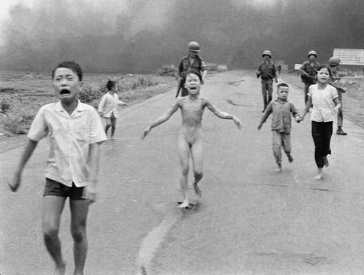 In this June 8, 1972 file photo, crying children, including 9-year-old Kim Phuc, center, run down Route 1 near Trang Bang, Vietnam after an aerial napalm attack on suspected Viet Cong hiding places as South Vietnamese forces from the 25th Division walk behind them. A South Vietnamese plane accidentally dropped its flaming napalm on South Vietnamese troops and civilians. From left, the children are Phan Thanh Tam, younger brother of Kim Phuc, who lost an eye, Phan Thanh Phouc, youngest brother of Kim Phuc, Kim Phuc, and Kim's cousins Ho Van Bon, and Ho Thi Ting. (AP Photo/Nick Ut)