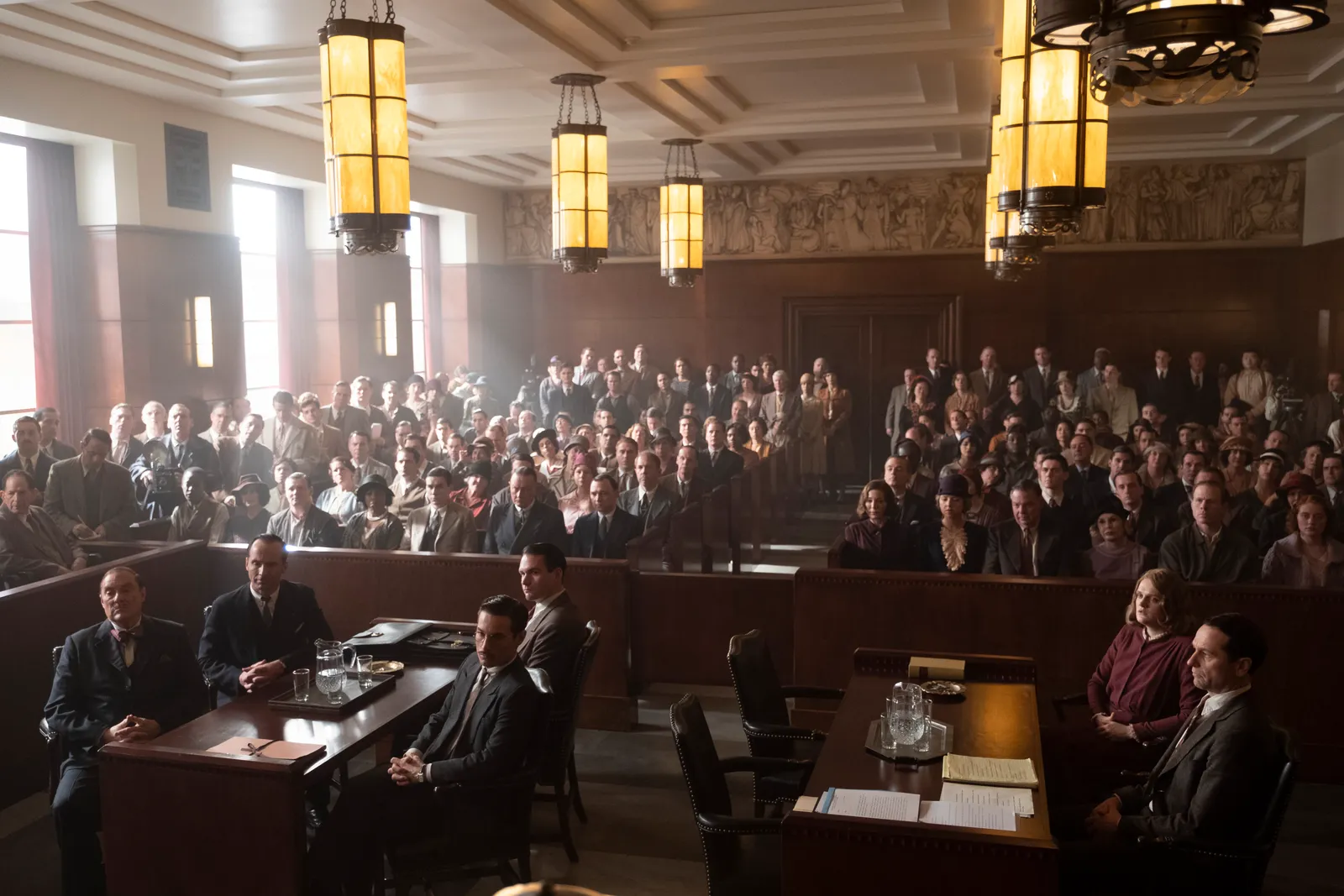 John P. Goldsmith was influenced by Streamline Moderne styles for the courtroom. Set decorator Halina Siwolop adapted actual light fixtures from a church and incorporated a frieze for design interest. Photo: Merrick Morton/HBO